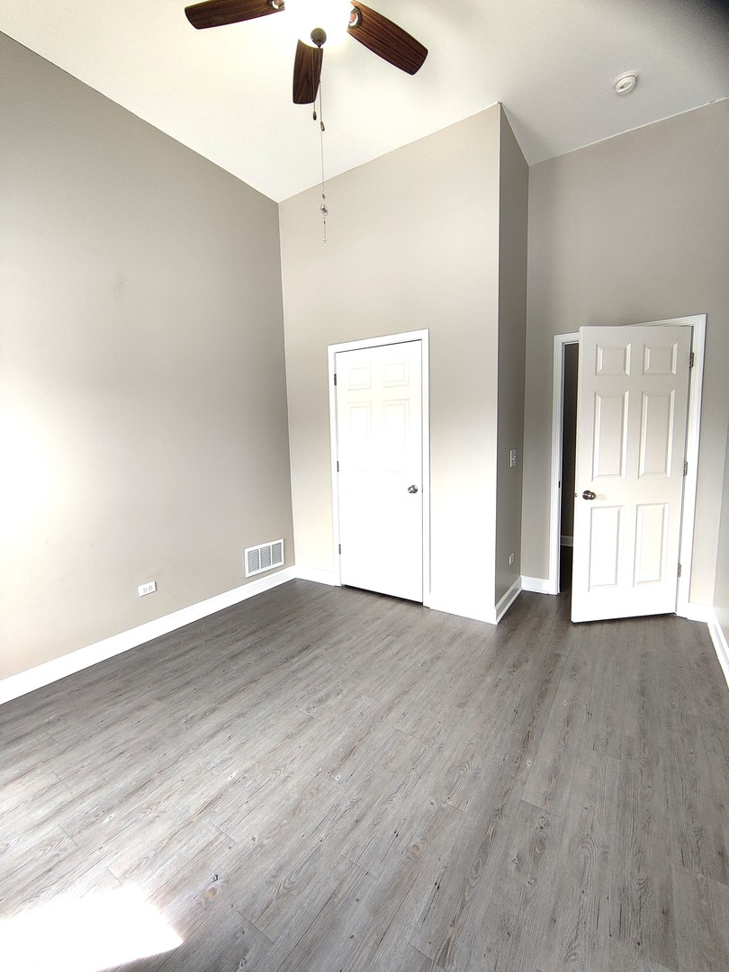 2026 North 3372nd Road, Unit 503 Ottawa, IL 61350 - Photo 10 of 49 an empty room with wooden floor and windows