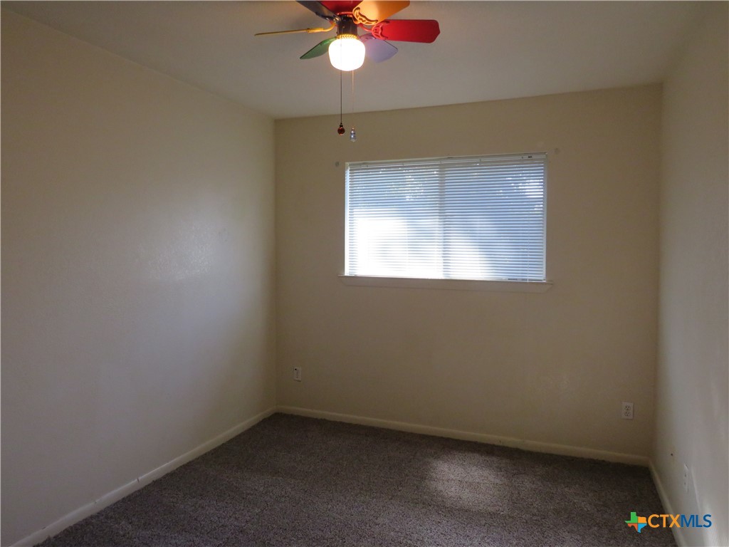 8221 Sam Rayburn Drive, Unit 103 Austin, TX 78753 - Photo 13 of 15 an empty room with a window and a fan
