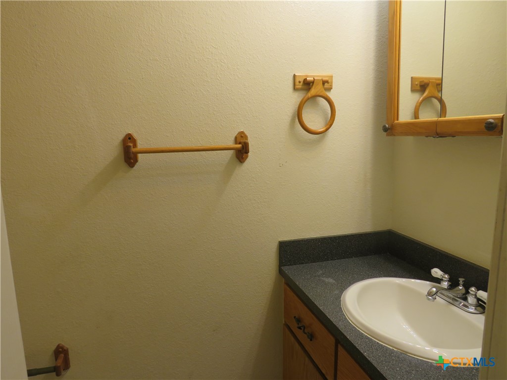 8221 Sam Rayburn Drive, Unit 103 Austin, TX 78753 - Photo 15 of 15 a bathroom with a sink and a mirror