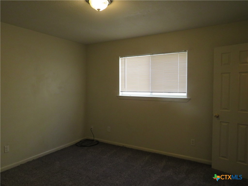 8221 Sam Rayburn Drive, Unit 103 Austin, TX 78753 - Photo 7 of 15 an empty room with a window