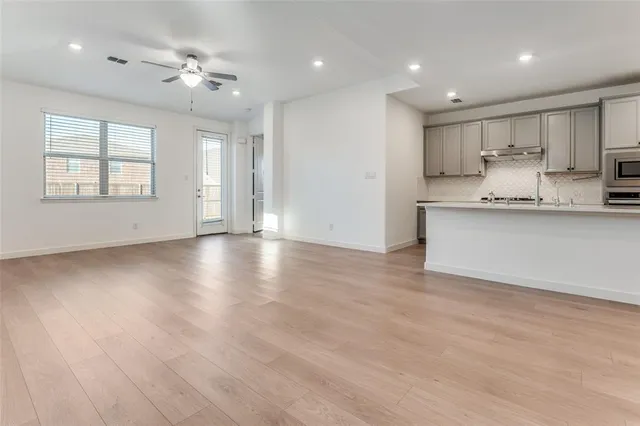 a view of kitchen with wooden floor and window