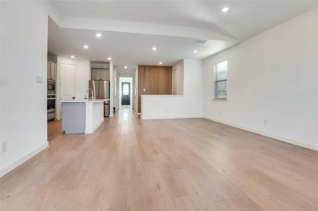 a kitchen with stainless steel appliances a refrigerator sink and cabinets