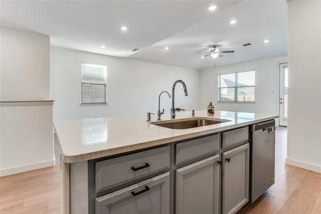 a kitchen with a sink and cabinets