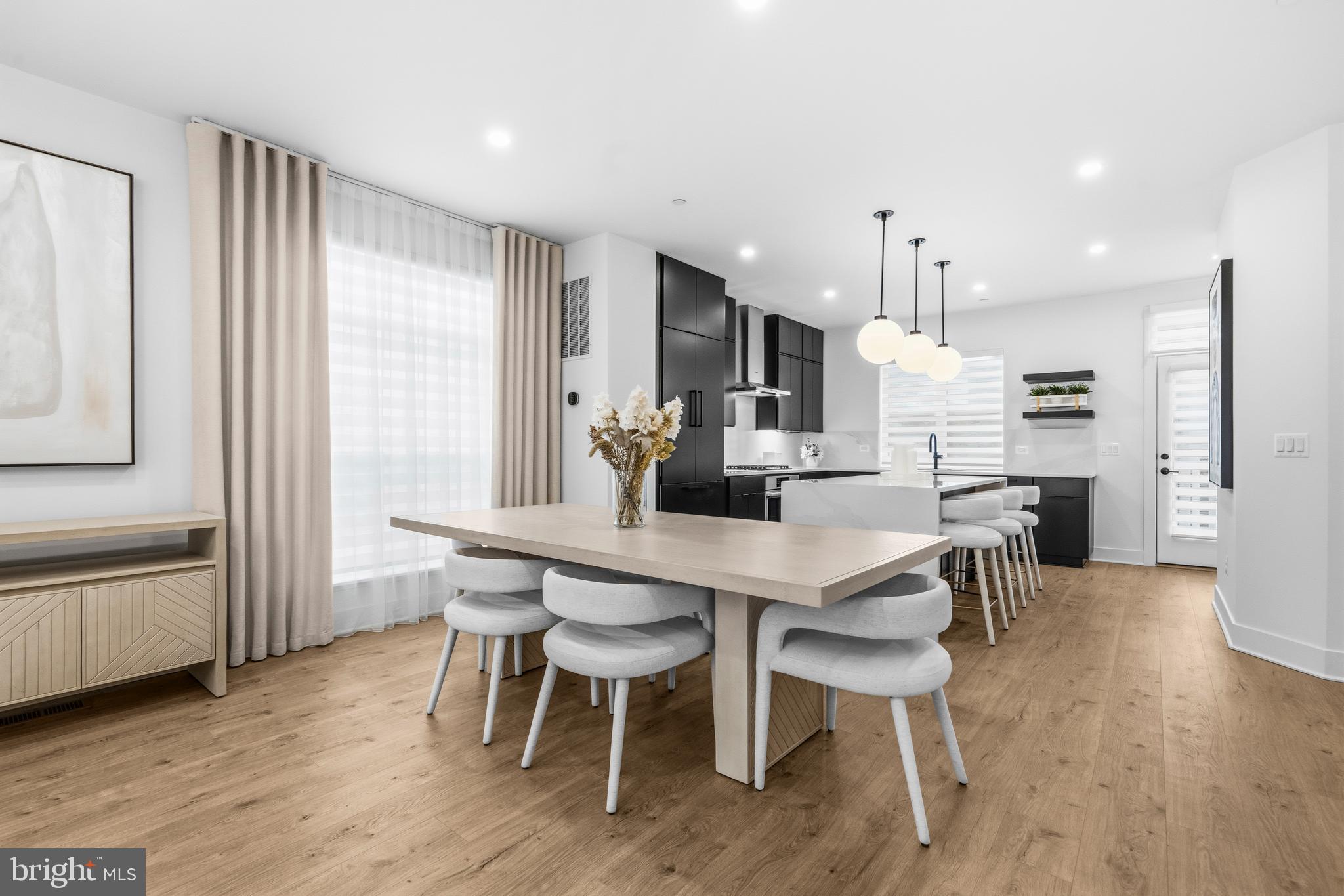 2040 Tysons Ridgeline Road Falls Church, VA 22043 - Photo 11 of 56 a kitchen with stainless steel appliances a dining table chairs and wooden floor