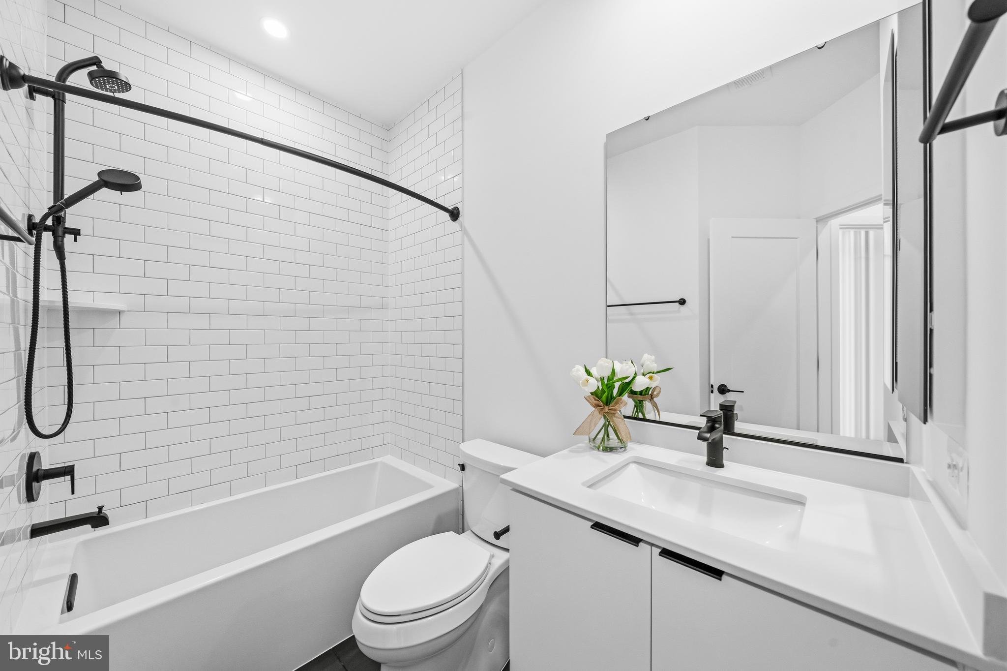 2040 Tysons Ridgeline Road Falls Church, VA 22043 - Photo 32 of 56 a bathroom with a sink toilet and shower