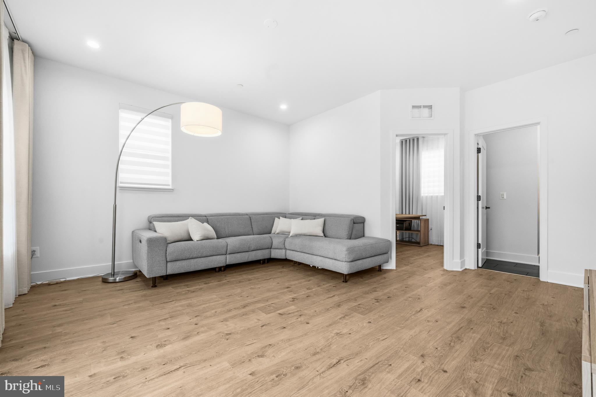 2040 Tysons Ridgeline Road Falls Church, VA 22043 - Photo 38 of 56 a living room with furniture and a wooden floor