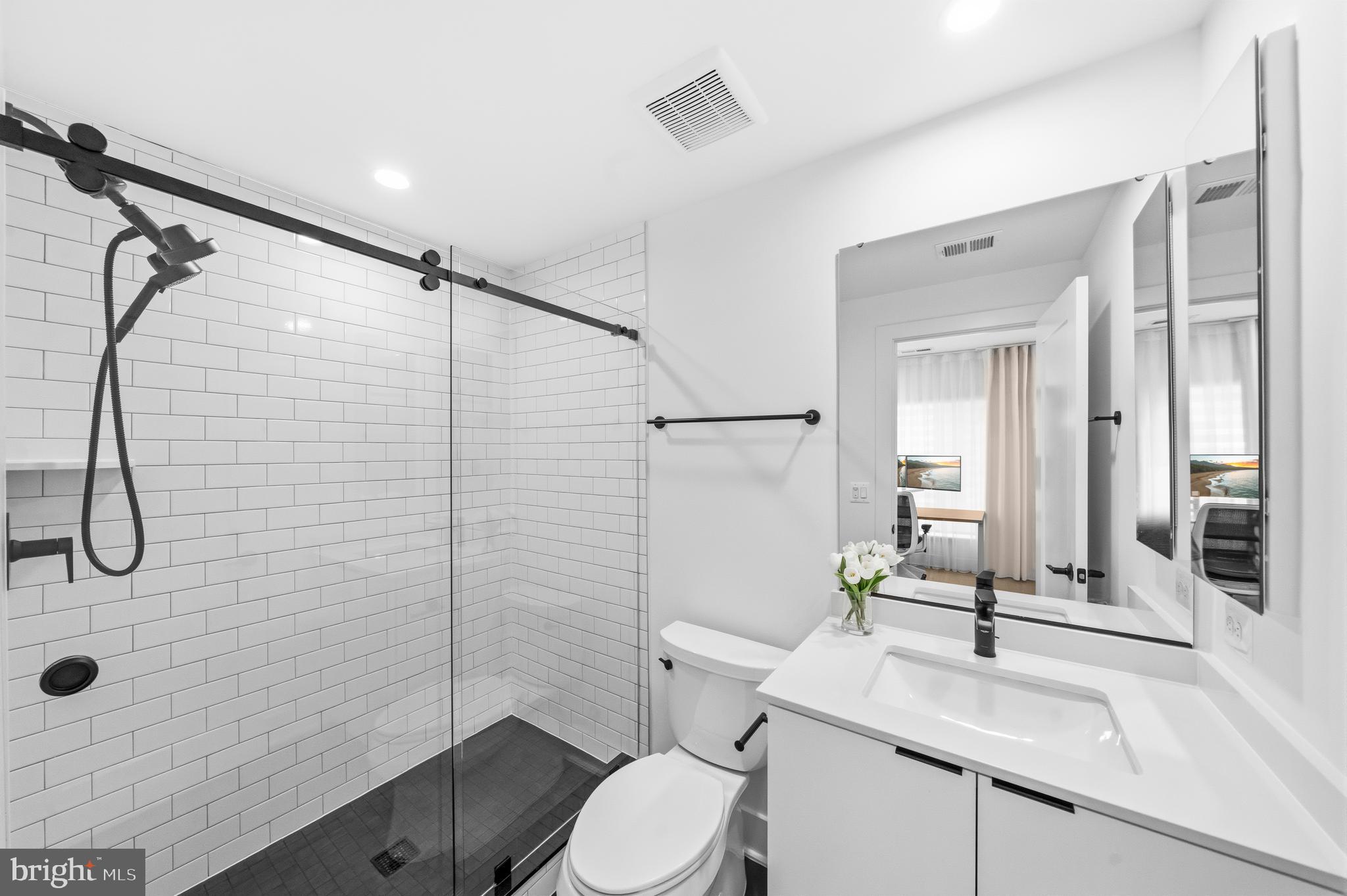 2040 Tysons Ridgeline Road Falls Church, VA 22043 - Photo 45 of 56 a bathroom with a sink a toilet and shower