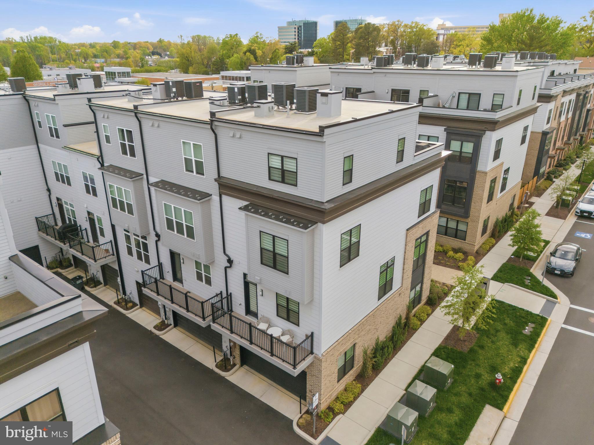 2040 Tysons Ridgeline Road Falls Church, VA 22043 - Photo 51 of 56 a view of a white building with a big yard and potted plants