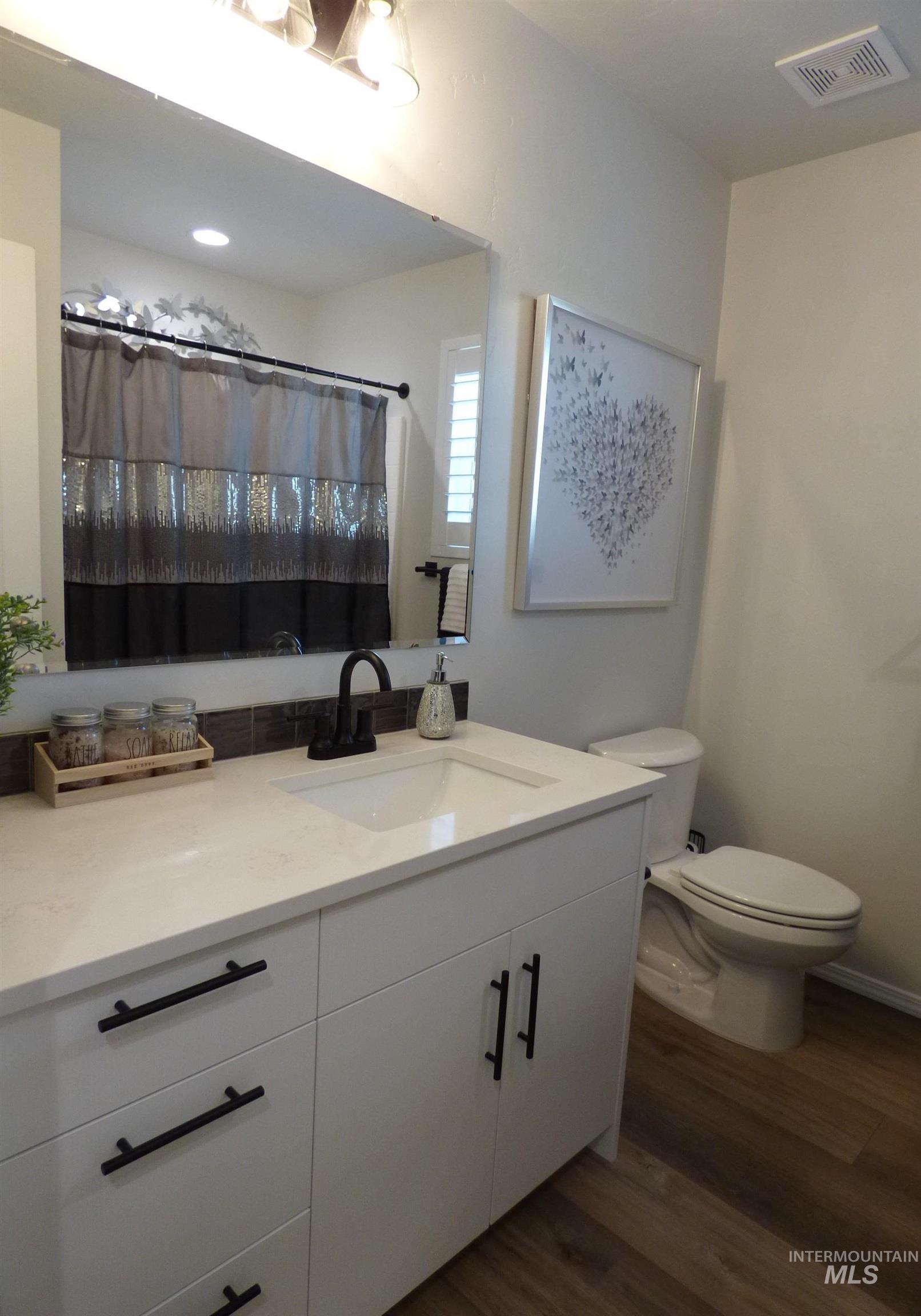 2708 East Buckaroo Drive Kuna, ID 83634 - Photo 14 of 48 Bathroom featuring a white vanity with matte black hardware, integrated sink, and light-toned countertop