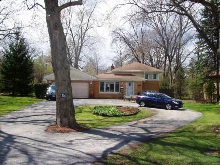 1150 Lee Road Northbrook, IL 60062 - Photo 1 of 11 a front view of a house with garden