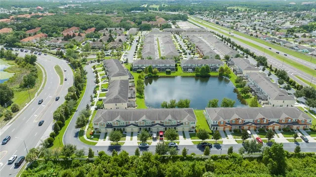 a kitchen with stainless steel appliances granite countertop a sink a microwave a refrigerator and cabinets