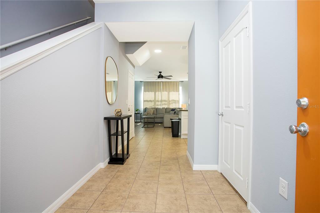 3181 Tocoa Circle Kissimmee, FL 34746 - Photo 15 of 87 a view of a hallway with wooden floor fireplace and living room