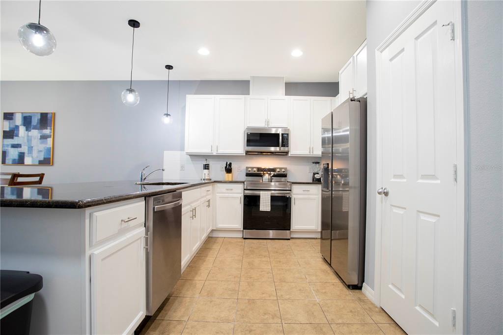 3181 Tocoa Circle Kissimmee, FL 34746 - Photo 17 of 87 a kitchen with stainless steel appliances a refrigerator sink and microwave