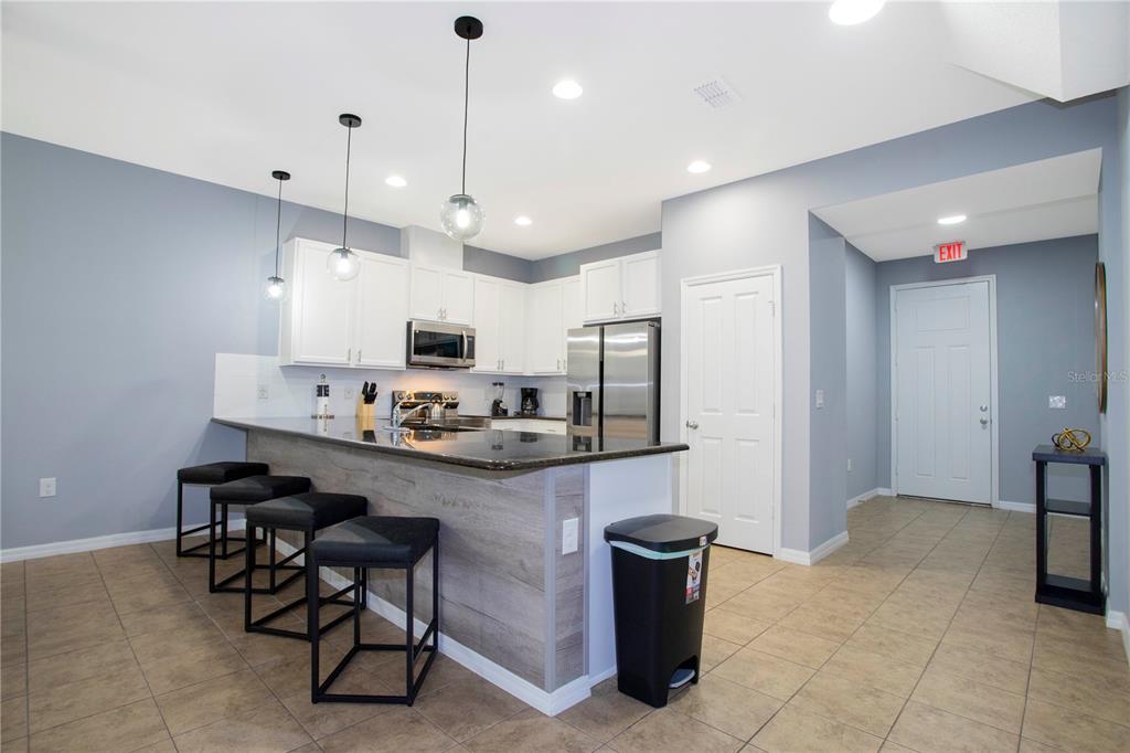 3181 Tocoa Circle Kissimmee, FL 34746 - Photo 20 of 87 a kitchen with stainless steel appliances granite countertop a sink refrigerator and cabinets