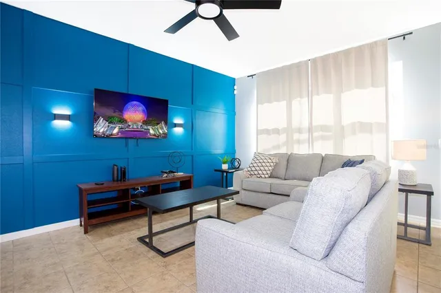 a view of a dining room with furniture a chandelier and wooden floor