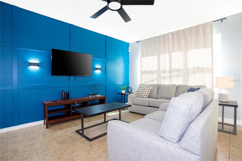 3181 Tocoa Circle Kissimmee, FL 34746 - Photo 23 of 87 a living room with furniture and a flat screen tv