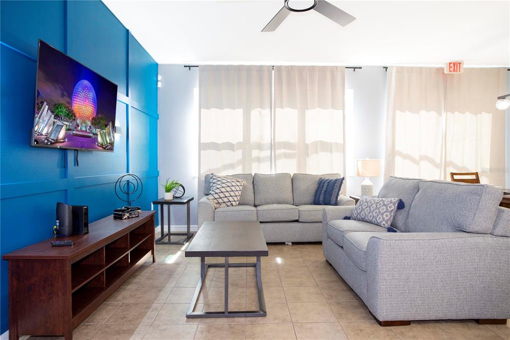 3181 Tocoa Circle Kissimmee, FL 34746 - Photo 24 of 87 a living room with furniture and a large window