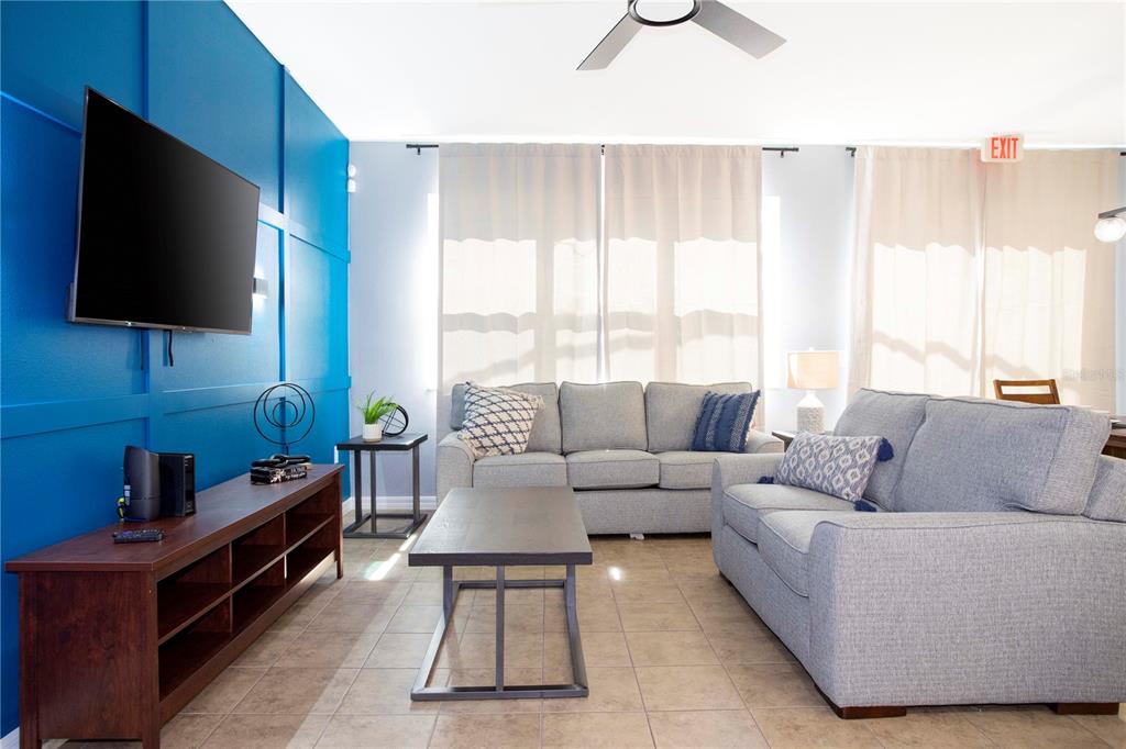 3181 Tocoa Circle Kissimmee, FL 34746 - Photo 25 of 87 a living room with furniture and a flat screen tv