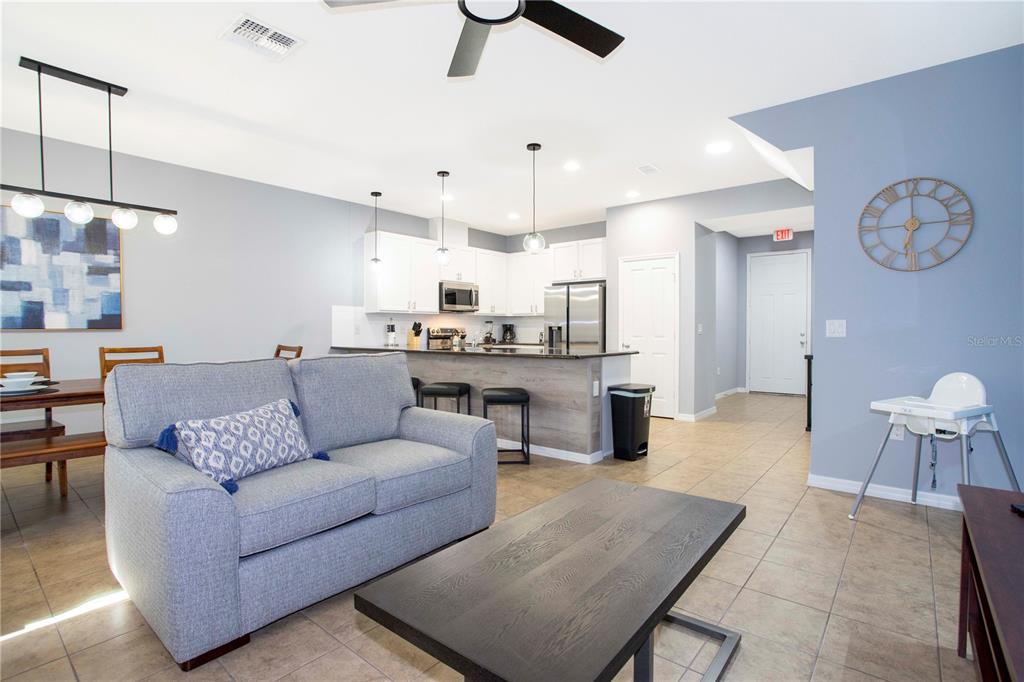 3181 Tocoa Circle Kissimmee, FL 34746 - Photo 26 of 87 a living room with furniture kitchen view and a chandelier