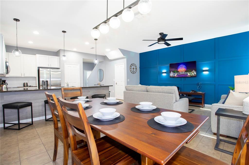 3181 Tocoa Circle Kissimmee, FL 34746 - Photo 31 of 87 a view of a dining room with furniture a chandelier and wooden floor