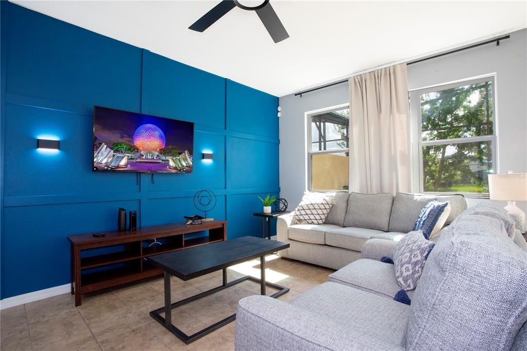 3181 Tocoa Circle Kissimmee, FL 34746 - Photo 38 of 87 a living room with furniture a ceiling fan and a window