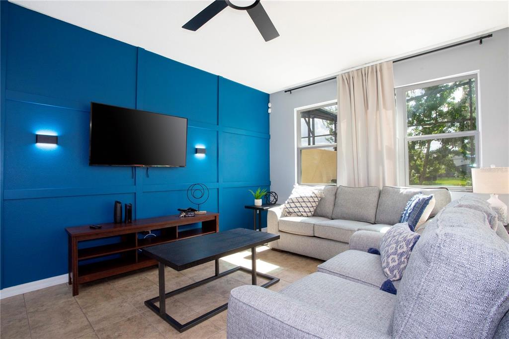 3181 Tocoa Circle Kissimmee, FL 34746 - Photo 39 of 87 a living room with furniture and a flat screen tv