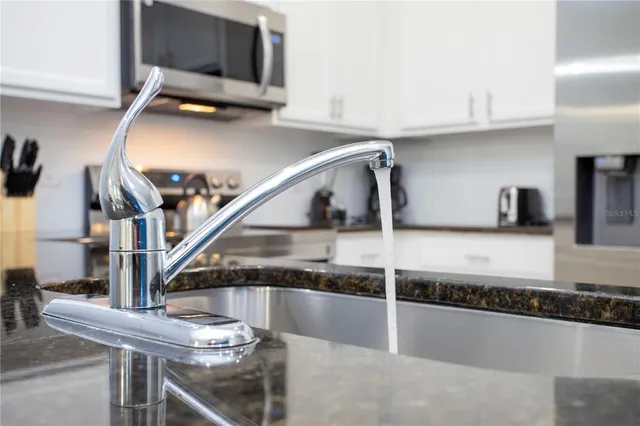 a bedroom with a bed and a ceiling fan