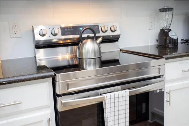 a bedroom with a bed a flat screen tv and a couch