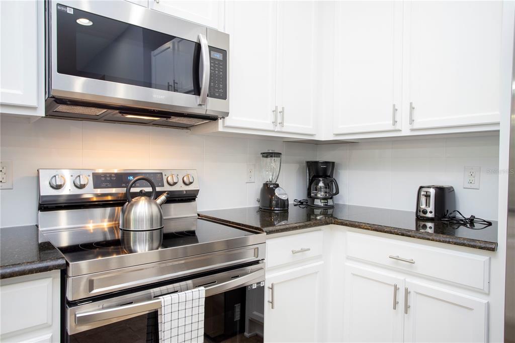 3181 Tocoa Circle Kissimmee, FL 34746 - Photo 48 of 87 a kitchen with appliances cabinets and a stove top oven
