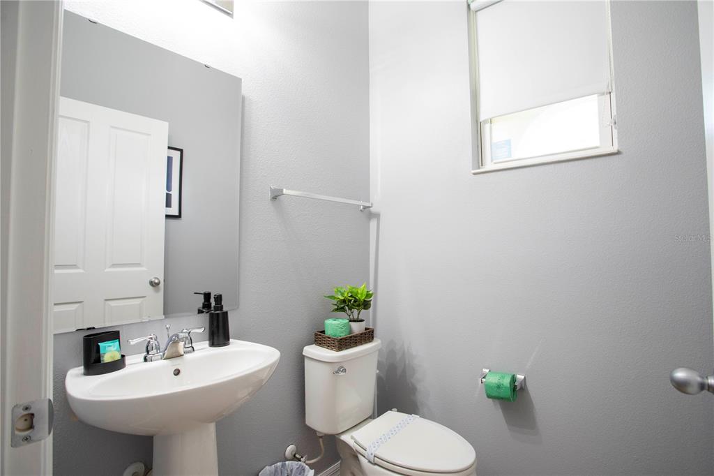 3181 Tocoa Circle Kissimmee, FL 34746 - Photo 52 of 87 a bathroom with a sink toilet and a mirror