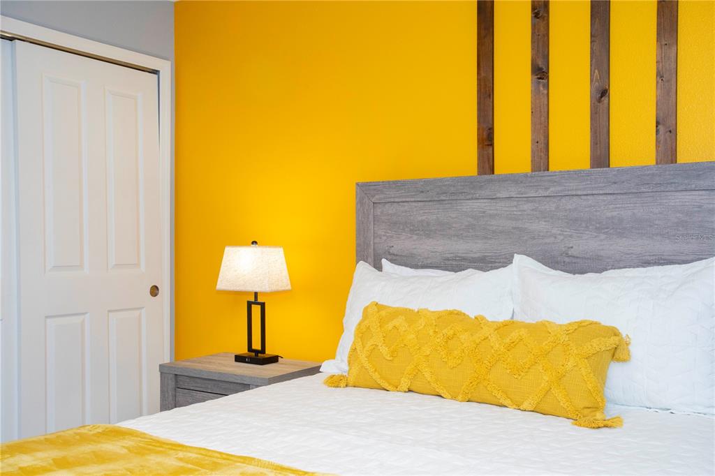 3181 Tocoa Circle Kissimmee, FL 34746 - Photo 64 of 87 a bedroom with a bed and lamp