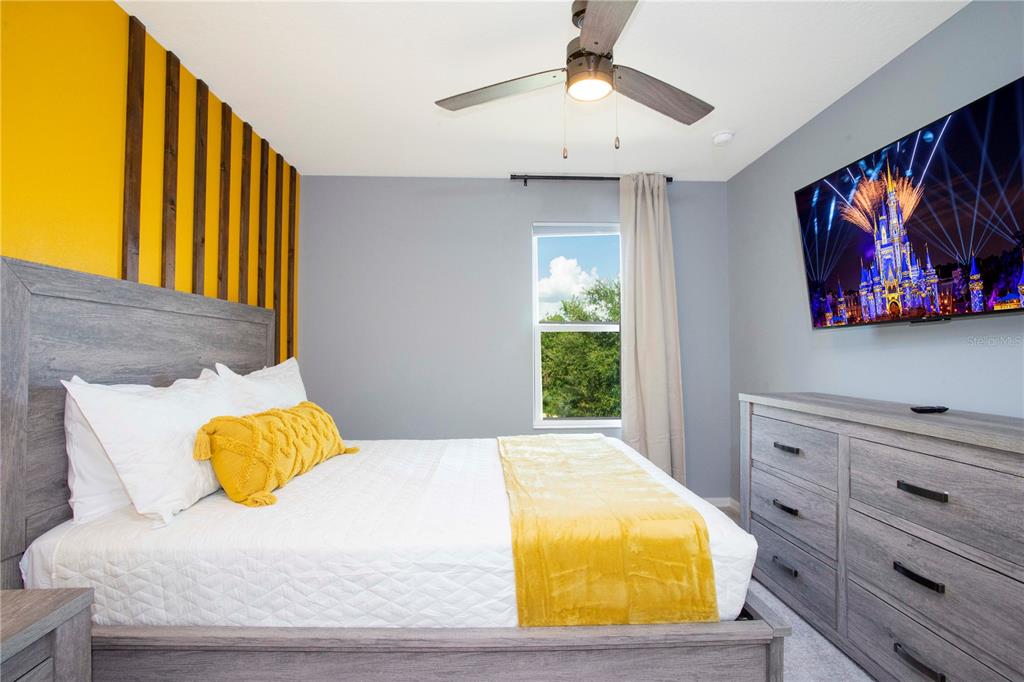 3181 Tocoa Circle Kissimmee, FL 34746 - Photo 66 of 87 a bedroom with a bed and painting on the wall