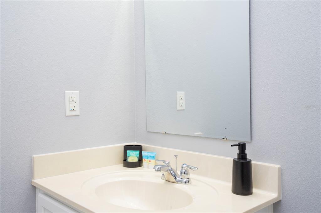 3181 Tocoa Circle Kissimmee, FL 34746 - Photo 69 of 87 a bathroom with a sink and a mirror