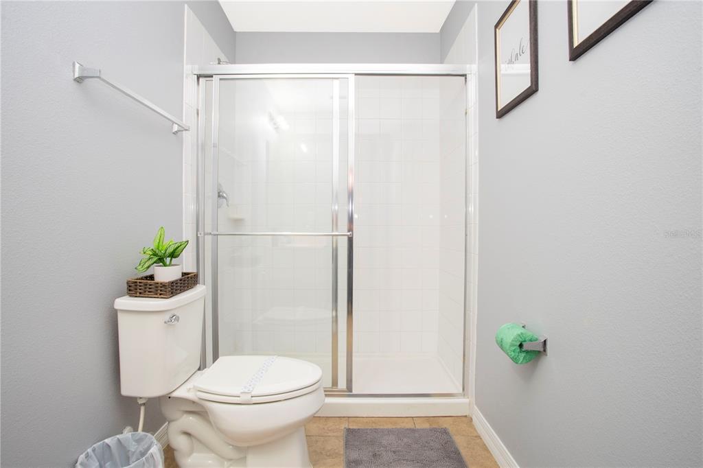 3181 Tocoa Circle Kissimmee, FL 34746 - Photo 70 of 87 a bathroom with a toilet and a shower