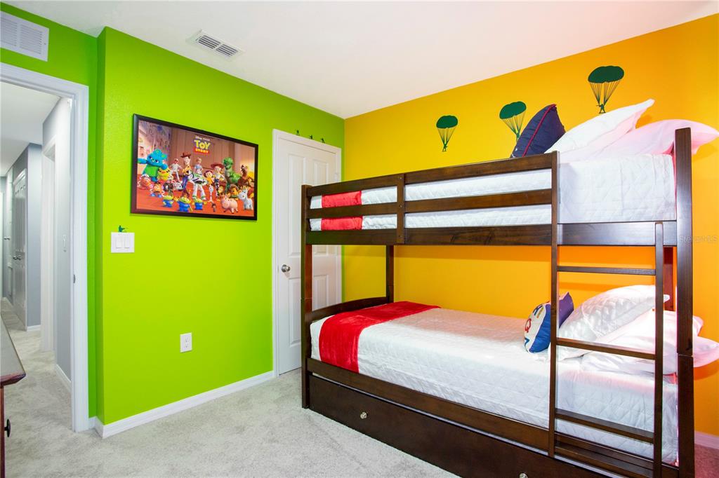 3181 Tocoa Circle Kissimmee, FL 34746 - Photo 75 of 87 a bedroom with a bed and a painting on the wall