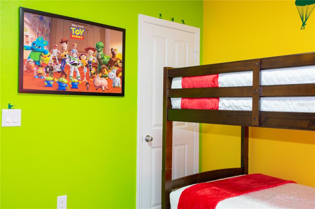 3181 Tocoa Circle Kissimmee, FL 34746 - Photo 76 of 87 a bedroom with a bed and wall painting