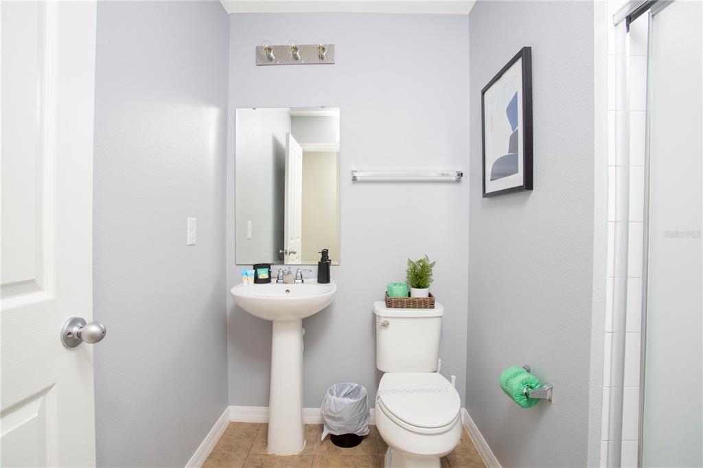 3181 Tocoa Circle Kissimmee, FL 34746 - Photo 77 of 87 a white toilet sitting next to a bathroom sink