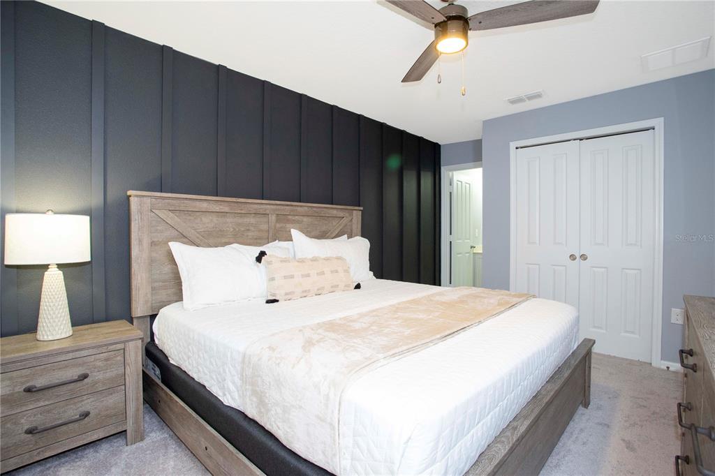3181 Tocoa Circle Kissimmee, FL 34746 - Photo 83 of 87 a bedroom with a bed and a ceiling fan