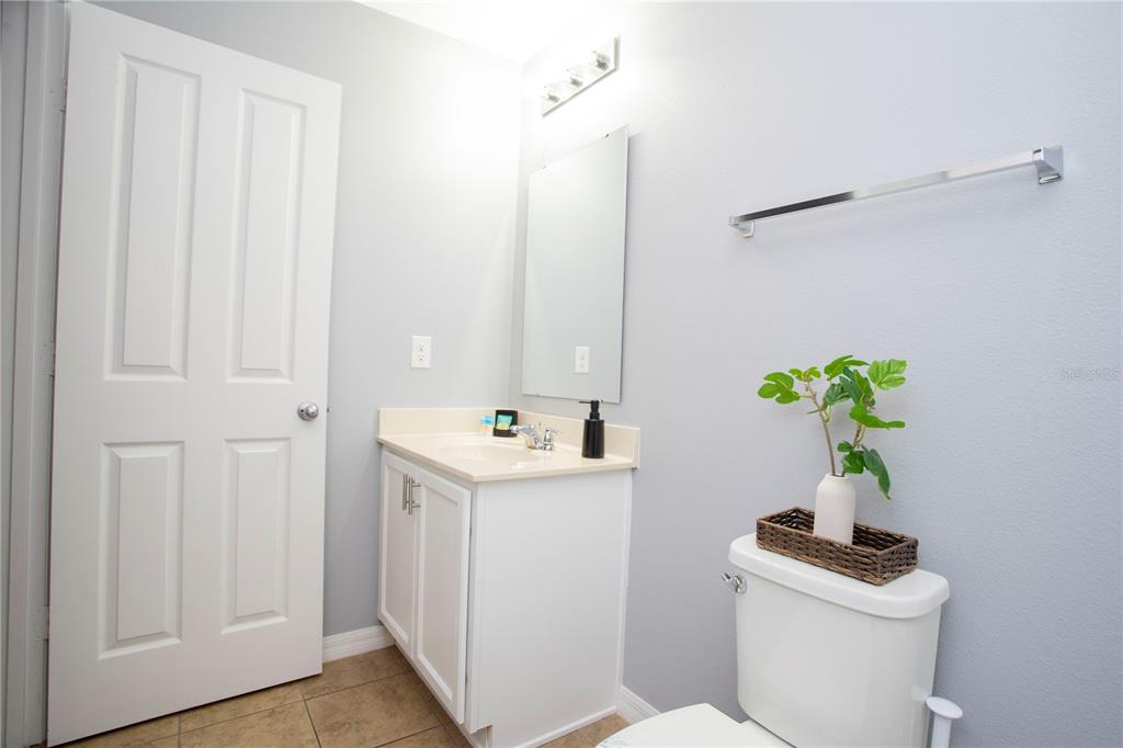 3181 Tocoa Circle Kissimmee, FL 34746 - Photo 87 of 87 a bathroom with a sink a toilet and a mirror