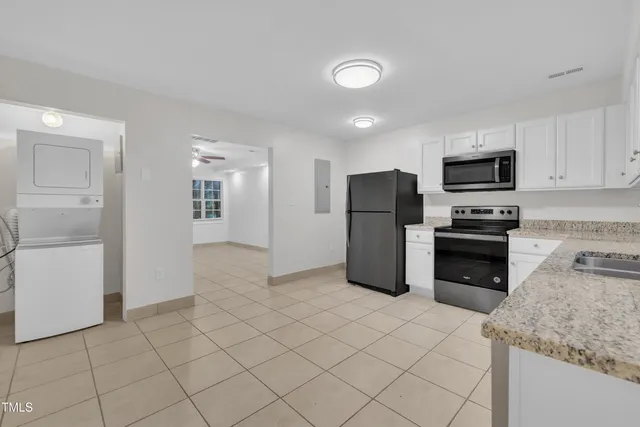 a kitchen with a stove sink and a refrigerator