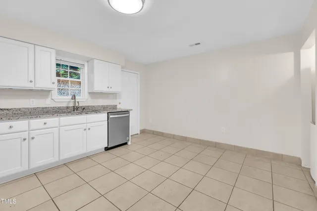a kitchen with white cabinets stainless steel appliances and a sink