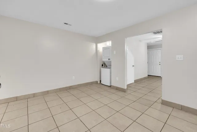 a kitchen with granite countertop a refrigerator and a stove top oven