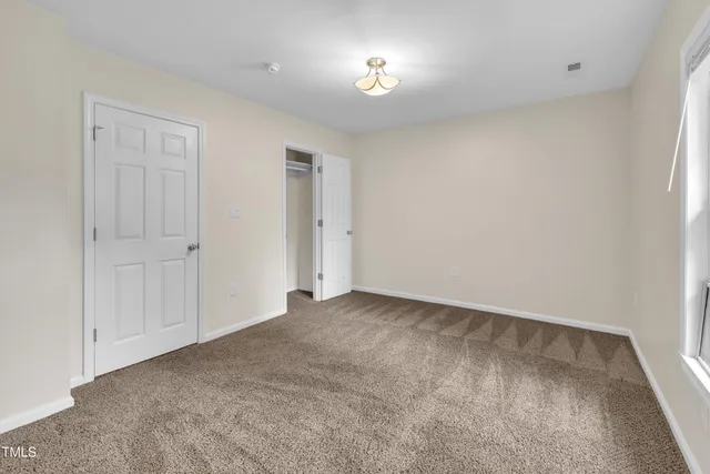 a bathroom with a granite countertop bathtub sink vanity mirror and toilet