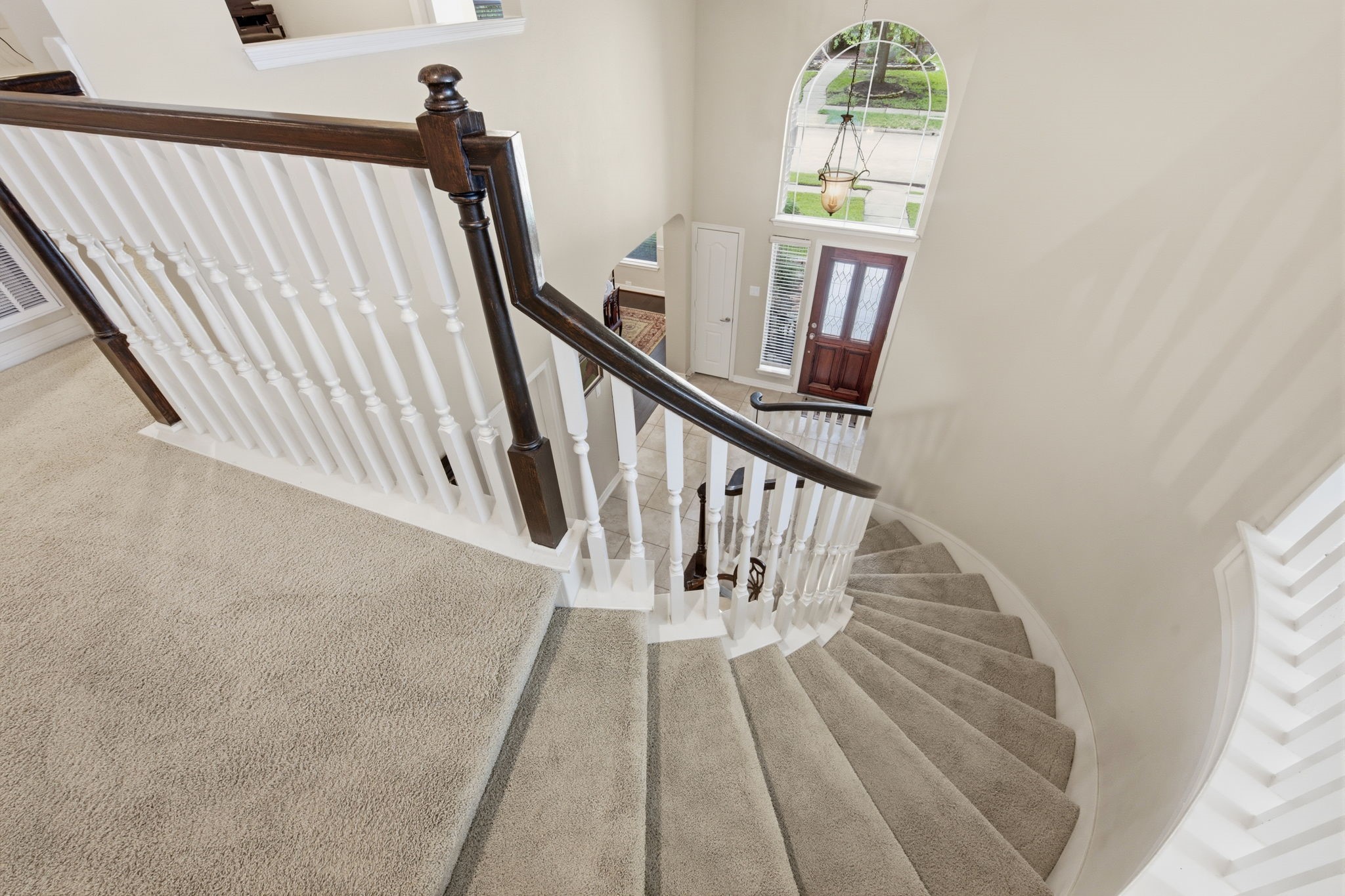 9722 Blue Cruls Way Spring, TX 77379 - Photo 6 of 45 Elegant stairway with vaulted ceilings. Carpeted stairway in neutral shade, Solid wood spindles.