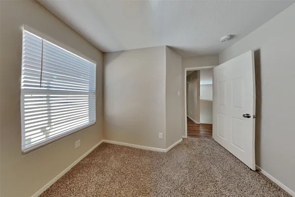 a view of an empty room with a window