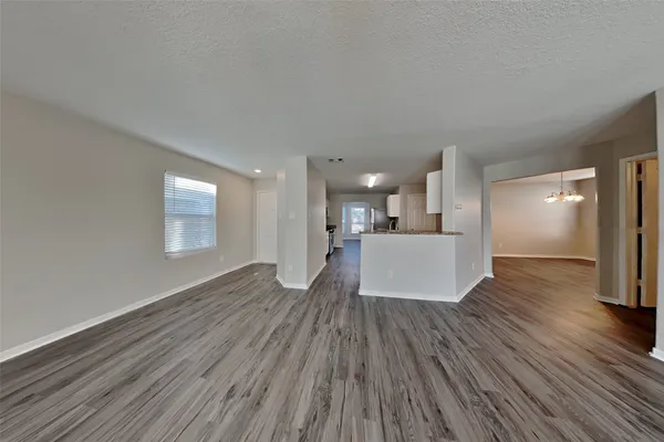 a view of a kitchen and wooden floor