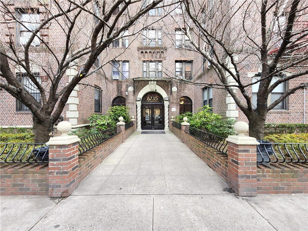 8735 Bay Parkway, Unit A57 Brooklyn, NY 11214 - Photo 2 of 13 a front view of a house with garden