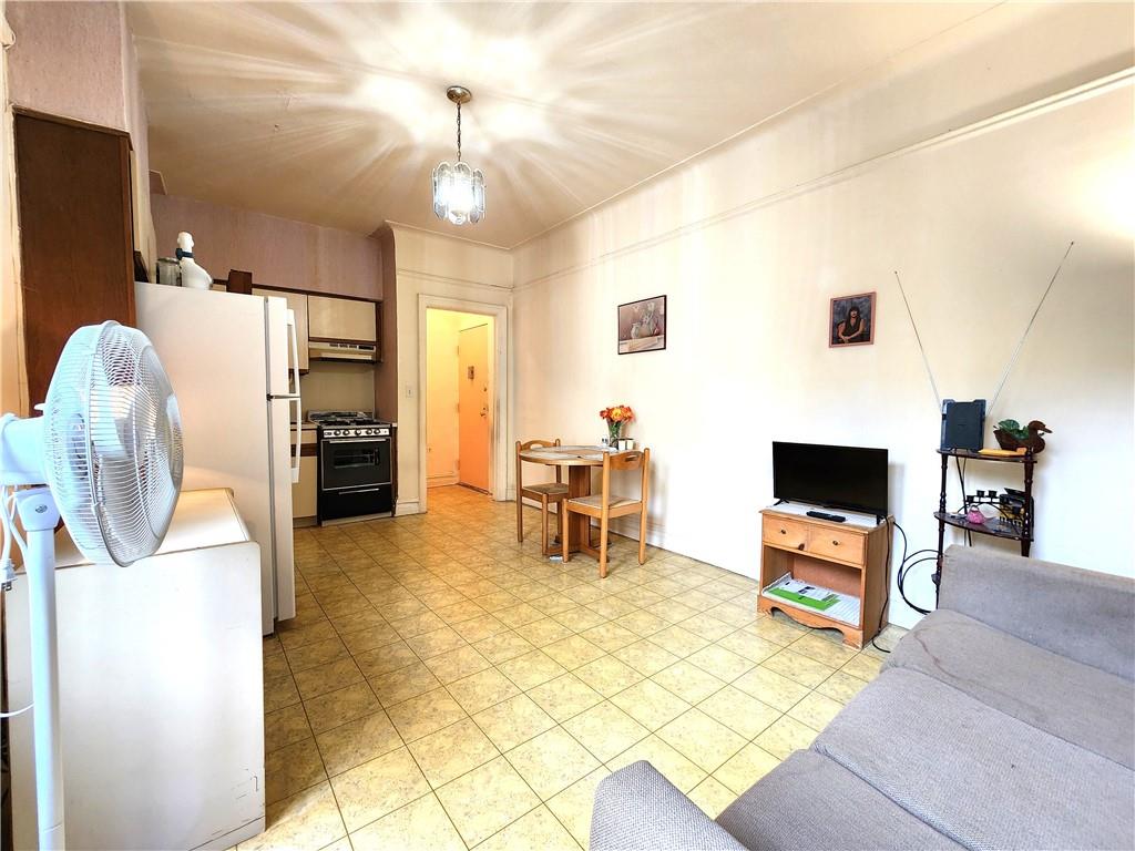 8735 Bay Parkway, Unit A57 Brooklyn, NY 11214 - Photo 9 of 13 a living room with furniture and a flat screen tv