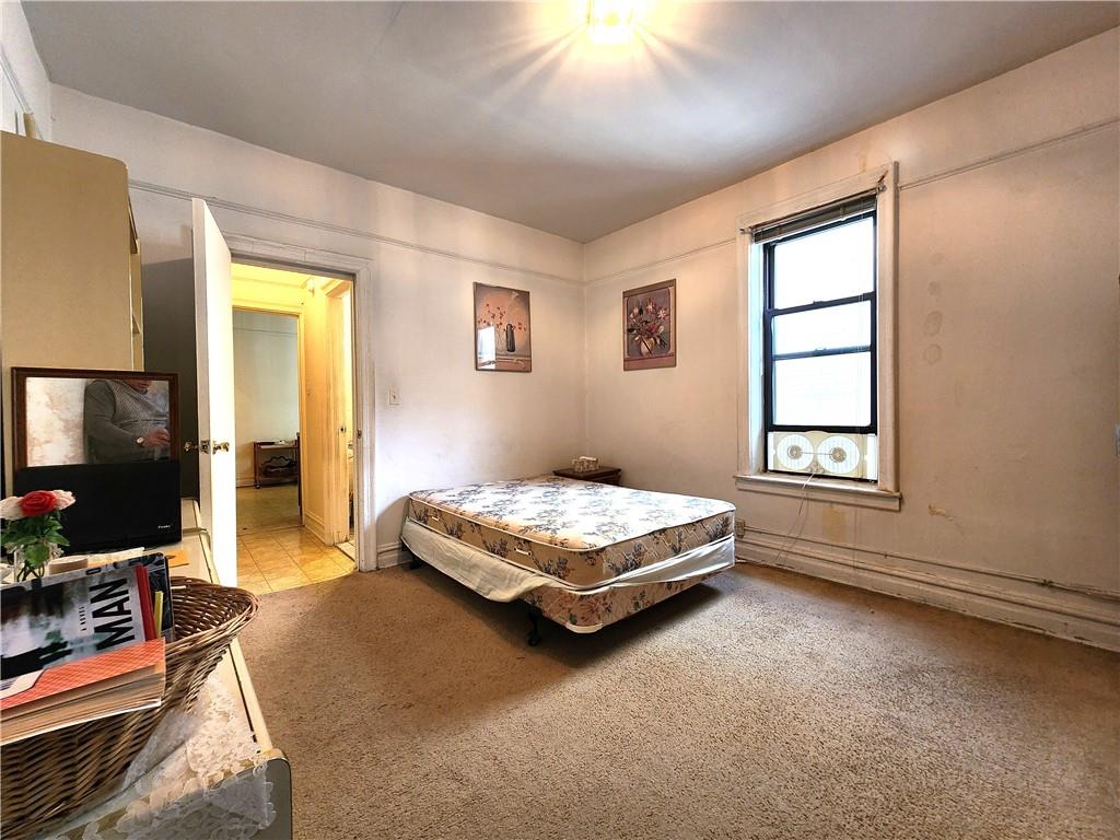 8735 Bay Parkway, Unit A57 Brooklyn, NY 11214 - Photo 10 of 13 a bedroom with a bed and a window