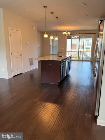a view of a kitchen with wooden floor and a floor to ceiling window